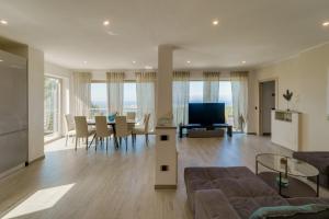 a living room with a couch and a table at Luxury Liam Villa with Pool and Sea View - Goelba in Portoferraio