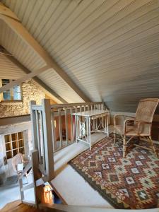 a room with a table and chairs in a attic at Gîte La Tour du Moulin in Saint-Étienne-de-Montluc