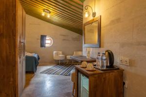 a room with a table and a mirror on the wall at Mabel Cappadocia in Uçhisar