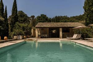 a swimming pool in front of a house at Casa Ostara in Condorcet