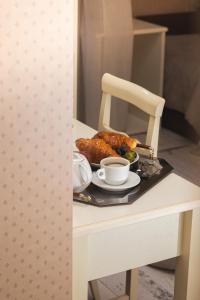 a table with a plate of food and cups on it at Palazzo Riario in Viterbo +38 photos