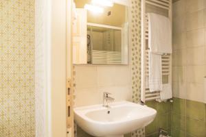 a bathroom with a sink and a mirror at Palazzo Riario in Viterbo