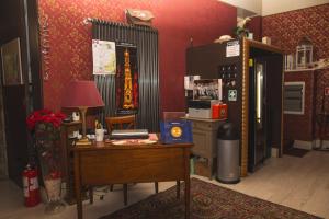 a room with a desk and a refrigerator at Palazzo Riario in Viterbo