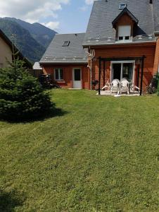 a house with two white sculptures on the front porch at Chalet lac Celinda in Saint-Mamet +4 photos