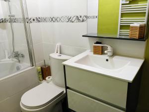 a bathroom with a sink and a toilet and a shower at Chalet lac Celinda in Saint-Mamet