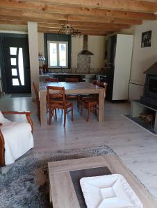 a kitchen and dining room with a table and chairs at Chalet lac Celinda in Saint-Mamet