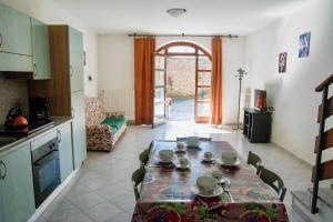 a kitchen and dining room with a table and chairs at Appartamenti Bonaventura in Tignale