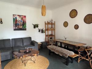 a living room with a couch and a table at Hakuna Woga Inn in Arusha