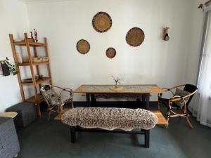 a living room with a wooden table and chairs at Hakuna Woga Inn in Arusha +51 photos