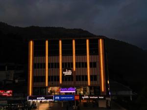 a large building with orange lights in front of it at Uphills boutique hotel in Kallar Vattiyar