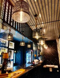 a bar in a restaurant with several chandeliers at Hotel Green Garden PVT LTD in Trincomalee