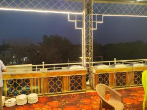 a balcony with a bunch of tables and chairs at Shri Mangal Palace in Gwalior +14 photos