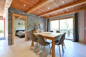 a dining room with a wooden table and chairs at Appartement Lisa - Dans chalet in Les Villards-sur-Thônes