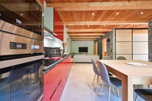 a kitchen with a wooden table and a dining room at Appartement Lisa - Dans chalet in Les Villards-sur-Thônes +12 photos