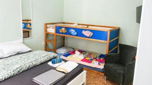 a small bedroom with a bunk bed and a chair at Konstantinou Apartments in Paralio Astros
