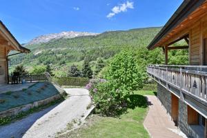 a balcony of a house with a view of a mountain at Appartement Alice - Dans chalet in Les Villards-sur-Thônes