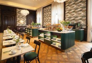 a restaurant with tables and chairs and a buffet at EST Hotel Palais Chotek NEW OPENING in Vienna +70 photos