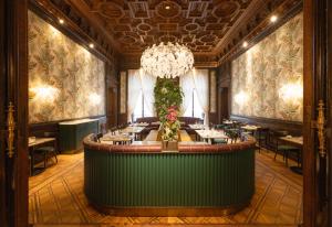 a restaurant with a large table in the middle at EST Hotel Palais Chotek NEW OPENING in Vienna
