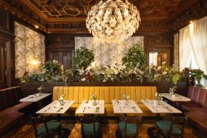 a dining room with tables and a chandelier at EST Hotel Palais Chotek NEW OPENING in Vienna