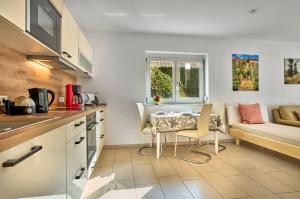 a kitchen with a table and a couch at Ferienwohnung im Goldtal in Bad Abbach +21 photos