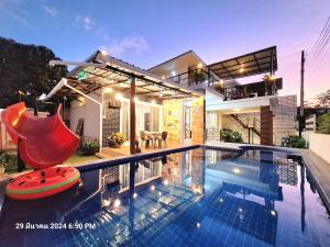 a house with a swimming pool in front of a house at Plus 1 2 3 Hua-Hin Private Poolvilla from beach 3km in Hua Hin