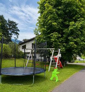 a playground with a trampoline in a yard at Haus Alpentraum in Patergassen