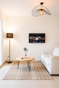 a living room with a couch and a table at Appartement Terrasse St Florent in Saint-Florent