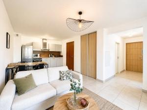 a living room with a couch and a table at Appartement Terrasse St Florent in Saint-Florent