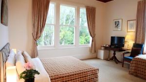 a hotel room with a bed and a window at The Devereux Boutique Hotel in Auckland