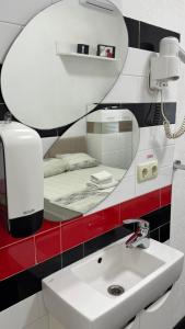 a bathroom with a sink and a mirror at Royal Suite in Odesa
