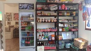 a refrigerator freezer sitting next to a shelf filled with drinks at Ann's Place in Cabangan +18 photos