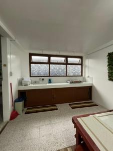 a large kitchen with a tub and a window at Ann's Place in Cabangan