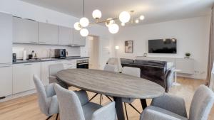 a kitchen and dining room with a table and chairs at Sali Homes - Opera Loge 2BR Balcony in Bayreuth