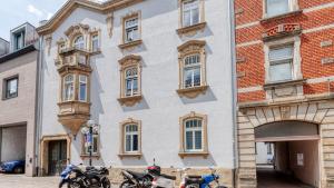 a group of motorcycles parked in front of a building at Sali Homes - Opera Loge 2BR Balcony in Bayreuth