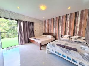 a bedroom with two beds and a large window at Plus 1 2 3 Hua-Hin Private Poolvilla from beach 3km in Hua Hin +98 photos