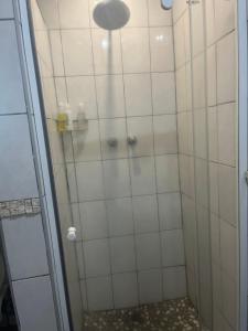 a bathroom with a shower with a glass door at Ingwenya Chalet in Sodwana Bay +6 photos