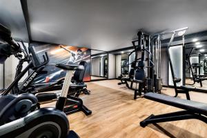 a gym with several treadmills and cardio machines at Hotel Riu Palace Nautilus - Adults Only in Torremolinos