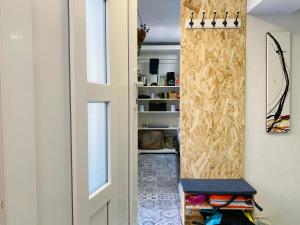 a room with a door and a chair in it at Hot Jacuzzi & Ice Bath Apartment in Ika