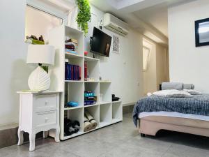 a bedroom with a bed and a white book shelf at Hot Jacuzzi & Ice Bath Apartment in Ika +9 photos