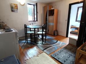 a kitchen with a table and chairs in a room at Vlasic Relax in Vlasic