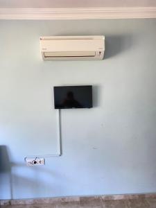 a television on a wall in a room at Emir Palas Hotel in Ekincik