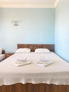 a bed with two towels on top of it at Emir Palas Hotel in Ekincik +22 photos