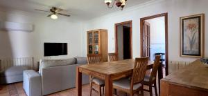 a living room with a table and a couch at Chalet con jardin cerca de la playa in Can Pastilla