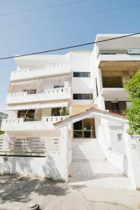 a white building with stairs in front of it at El Condor Casa in Rhodes Town