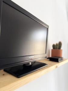 a flat screen tv sitting on a wooden shelf at ZenZone House in La Spezia