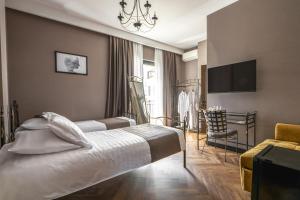 a hotel room with a bed and a chair at Golden Boutique Hotel in Tbilisi City