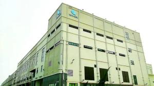 a large white building with a clock on the top at HP Temasek Hotel in Malacca