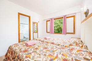 a bedroom with a bed with a colorful bedspread at Apartamento Felipe 2-4 in Cala d´Or +21 photos