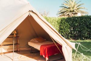 a tent with a bed inside of it at Glamping Spot - Penmarch in Penmarch