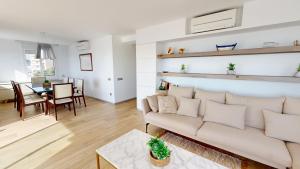 a living room with a couch and a table at Apto Panoramic in L'Ampolla